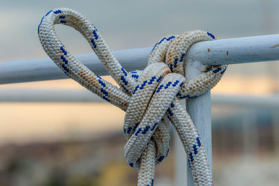Close-up of rope tied on tube railing
