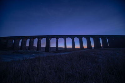 Bridge against sky at night