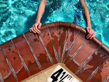 Cropped hands in swimming pool