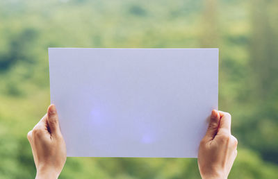 Close-up of hand holding paper