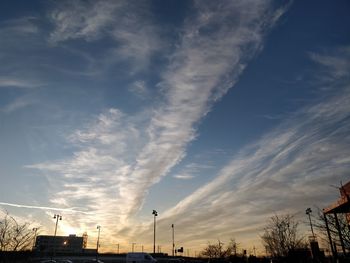 Low angle view of silhouette trees against sky