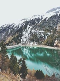 Scenic view of lake and mountains against clear sky