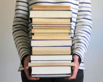 Low section of woman standing against white background