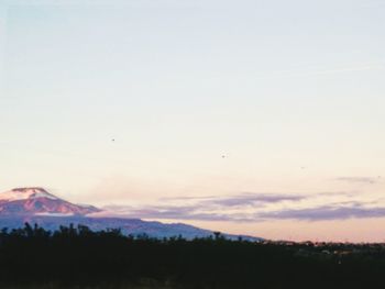 Scenic view of silhouette mountains against sky at sunset