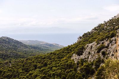 Scenic view of green mountains against sky