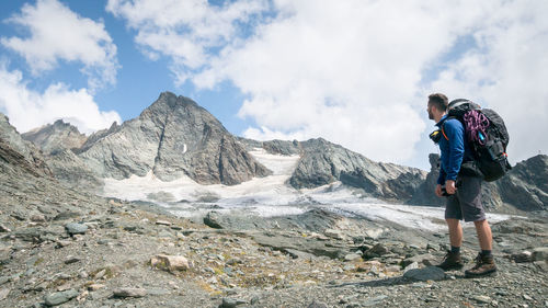 Mountaineer looking up at mountain he is about to climb, austrian alps, europe