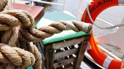 High angle view of rope tied to moored at harbor