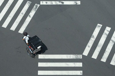 High angle view of man crossing road