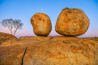 Low angle view of rock formation against sky