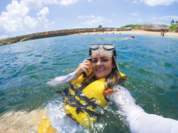 Portrait of woman swimming in sea