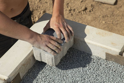 Low section of man working on wood