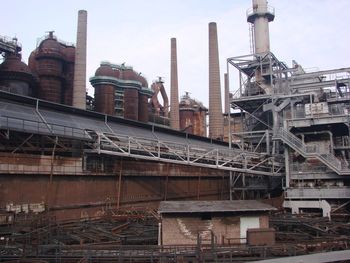 Low angle view of old factory against sky