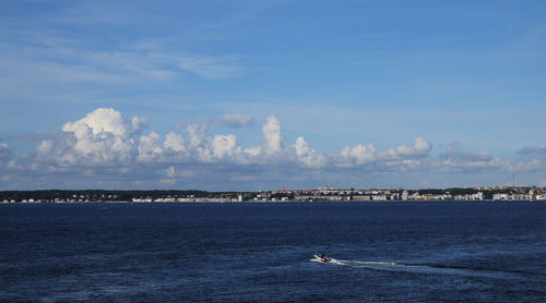 Motorboat in blue sea against sky