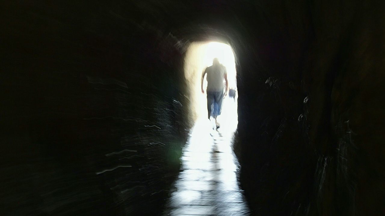 REAR VIEW OF SILHOUETTE MAN WALKING IN WATER