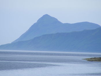 Scenic view of mountains against cloudy sky