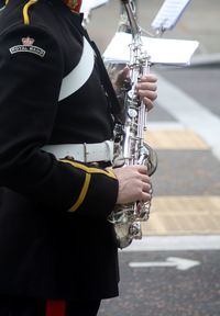 Midsection of man with saxophone