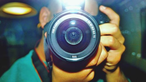 Reflection of man in mirror while holding camera