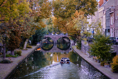 View along the tree-lined oudegracht  canal in utrecht city centre. autumn evening.