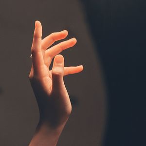 Close-up of human hand against black background