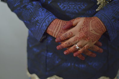 Midsection of bride with henna tattoo