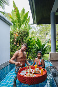 High angle view of woman sitting in swimming pool