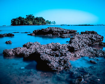 Scenic view of sea against clear blue sky