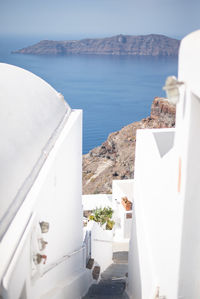 White building by sea against sky