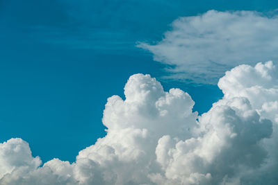 White fluffy clouds on blue sky. soft touch feeling like cotton. white puffy cloudscape with space.