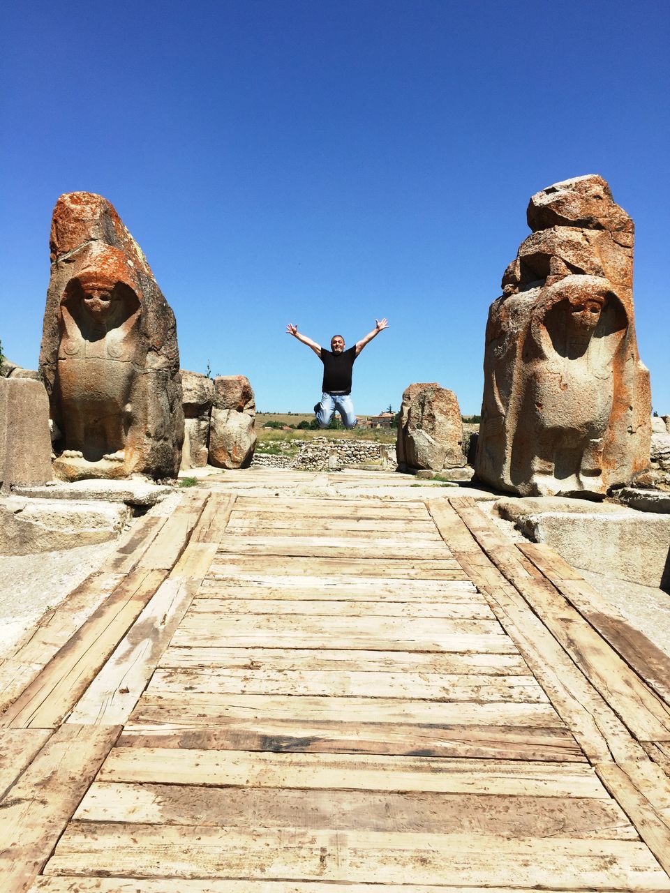 clear sky, copy space, blue, built structure, architecture, history, stone material, old ruin, building exterior, ancient, sunlight, old, low angle view, sculpture, the past, rock - object, statue, steps, day, outdoors