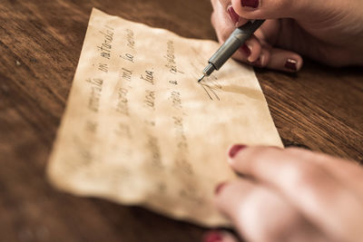 Close-up of human hand holding paper