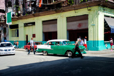 Men on car in city