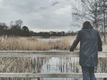 Man standing on lakeshore