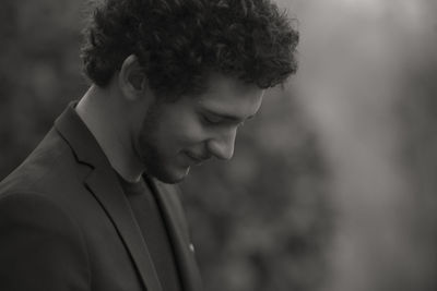 Portrait of young man looking away outdoors