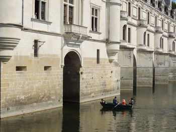 Boat in river against building