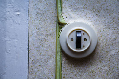 Close-up of light switch on wall