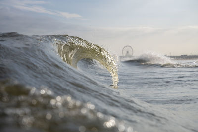 Waves in sea against sky