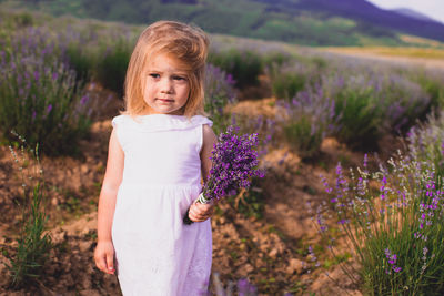 Portrait of girl standing on field