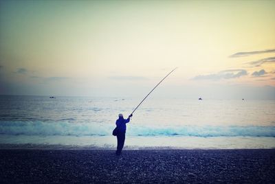 Silhouette of woman standing on beach