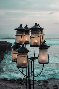 Outside lanterns with candles on ocean background. romantic sunset on sea coast. bali, canggu.