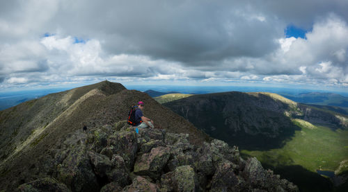 Man sitting on rocks at mount katahdin