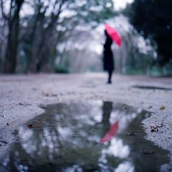 Woman jumping in pond