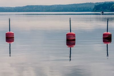 Red wooden post in lake