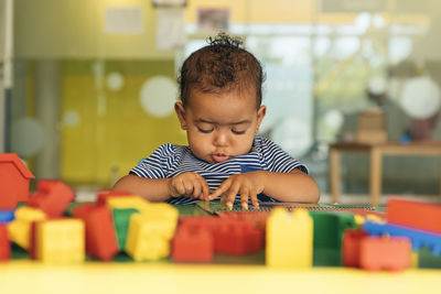 Cute boy playing with toy at home