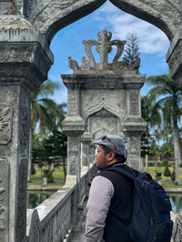 Man standing in front of historical building