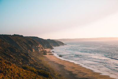 Scenic view of sea against clear sky during sunset