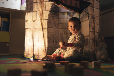 Portrait of cute girl sitting at home