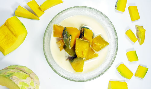 High angle view of chopped fruits in plate on table