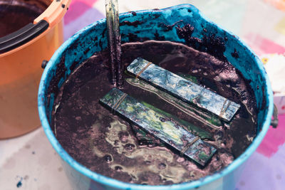 High angle view of paintbrushes in container