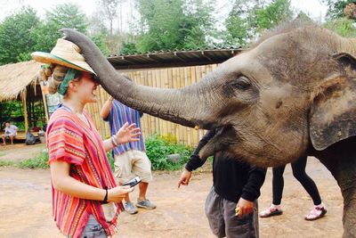 Full length of man eating elephant