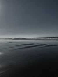 Scenic view of beach against clear sky